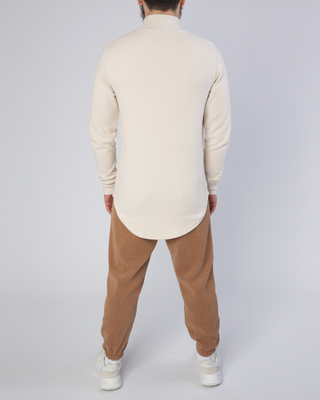Col roulé beige de Qaba'il
